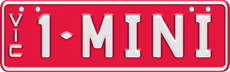 Custom plate slimline - white embossed text on red background, two sets of characters separated by a diamond divider (for example 1- MINI), with VIC vertically down on the left side. Eight screws on the edges of the plate
